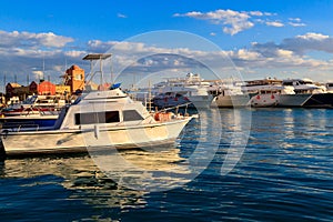 White yachts in sea harbor of Hurghada, Egypt. Port with tourist boats on the Red Sea