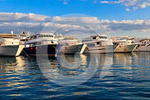 White yachts in sea harbor of Hurghada, Egypt. Port with tourist boats on the Red Sea