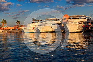 White yachts in sea harbor of Hurghada, Egypt. Port with tourist boats on the Red Sea