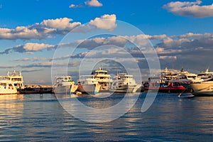 White yachts in sea harbor of Hurghada, Egypt. Port with tourist boats on the Red Sea