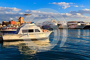White yachts in sea harbor of Hurghada, Egypt. Port with tourist boats on the Red Sea