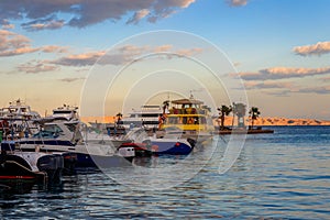 White yachts in sea harbor of Hurghada, Egypt. Port with tourist boats on the Red Sea