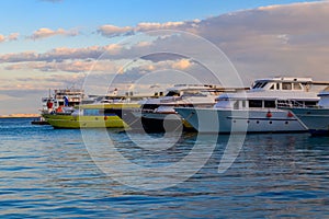 White yachts in sea harbor of Hurghada, Egypt. Port with tourist boats on the Red Sea