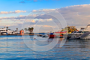 White yachts in sea harbor of Hurghada, Egypt. Port with tourist boats on the Red Sea