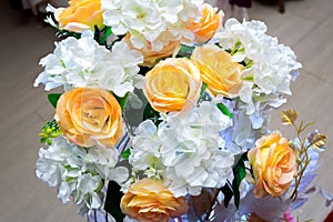 White and yellow artificial paper flowers vase.