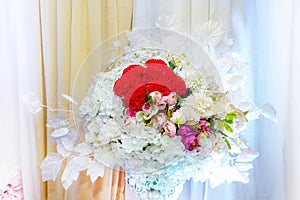 White and yellow artificial paper flowers vase.