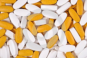 White and yellow pills background