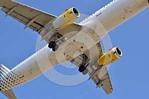 White and yellow plane undercarriage from below