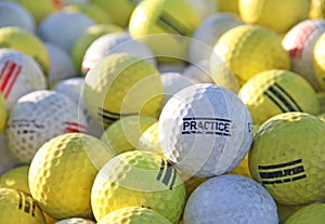 White and Yellow Practice Golf Balls at golf course hitting range