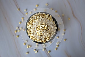 White and Yellow Roasted gram dal in bowl on blur background.