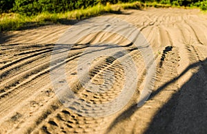 White and yellow sand in the desert with quad bike and car jeep tracks