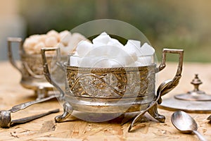 White and yellow sugar (cubes) in silver containers - antique bowls