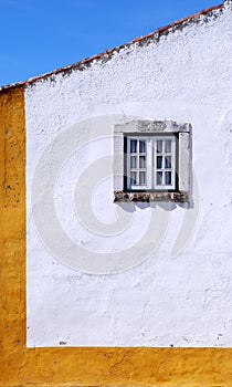 White and yellow wall and window in medieval house, Portugal