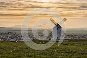 Whiteashed Spanish windmill above the plains of La Mancha in central Spain at sunset