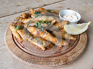 Whitebait deep fried on a wooden platter