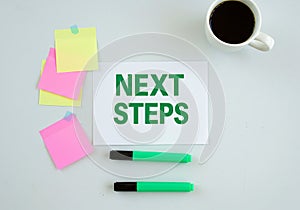 whiteboard next steps sticky notes green marker coffee mug