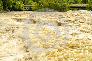 Whitecaps and Whirlpools Can Be Seen in a Turbulent River after Heavy Rains.