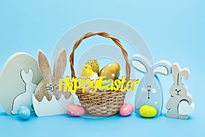 Whiteeggs in the nest and yellow chicks on a blue background.  An Easter card with a copy of the place for the text