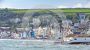 Whitehead Promenade, landscape with colored houses and waves on Northern Ireland East Coast in UK