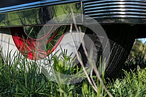 Whitewall, rear tire with chrome side wall on vintage car.