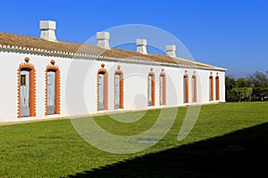 Whitewashed facades in Tavira Island in Portugal