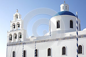 Whitewashed houses and blue dome church by the Aegean sea, Santoriniin Oia, Santorini, Greece. Famous blue domes in Oia village,