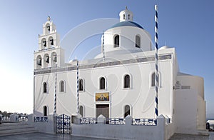 Whitewashed houses and blue dome church by the Aegean sea, Santoriniin Oia, Santorini, Greece. Famous blue domes in Oia village,