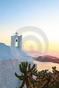 Whitewashed houses with pink sunset over the Aegean Sea in Ios, Greece