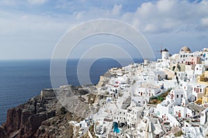 Whitewashed Houses and Windmill on Cliffs with Sea View in Oia,