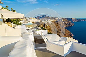 Whitewashed luxury hotel terraces on Caldera cliff edge Santorini Greece
