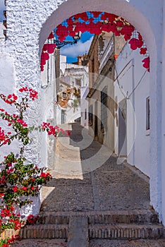 Whitewashed street of the old town of Arcos de la Frontera, one of pueblos blancos, in Spain photo