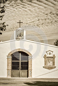Whitewashed traditional church or hermita in a small village in Spain. Jamilena. Monochrome, sepia photo