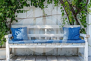 Whitewashed wooden garden bench with blue cushions. Generative AI