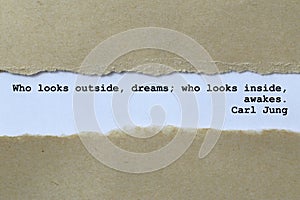 who looks outside dreams who looks inside awakes carl jung on white paper