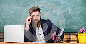 Who ready to answer question. Teacher bearded hipster with eyeglasses sit in classroom chalkboard background. School