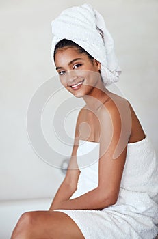 Who said you cant pamper yourself everyday. Portrait of an attractive and relaxed young woman wrapped in a towel at home