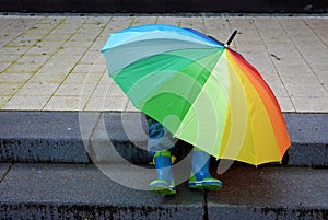 Who is under the umbrella, boy or girl?