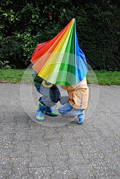 Who is under the umbrella, boy or girl?