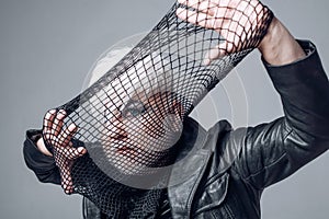 Who wants to play. Transgender man cover face with fishnet. Male makeup look. Fetish fashion. BDSM fashion accessory
