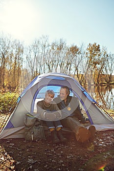 Who would say no to fresh air and a stressless weekend. a senior couple camping together in the wilderness. photo