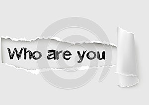 Who are you question written under the curled piece of White torn paper