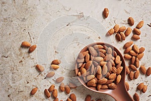 Whole Almonds in a Brown Spoon