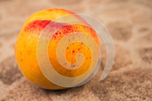 Whole apricot on concrete