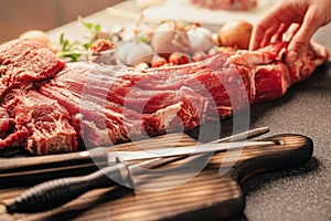 Whole beef tenderloin prepared for cutting and portioning. Butchering a big chunk of meat. Seasoning and cooking meat roast or