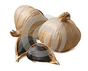 Whole black garlic bulbs and cloves isolated on white background