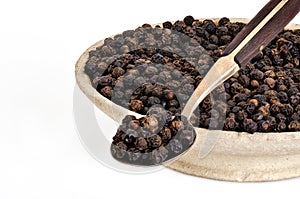 Whole Black Pepper in Old stone bowl