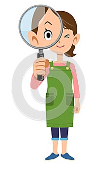 The whole body of a woman wearing an apron looking through a magnifying glass