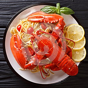 Whole boiled lobster with Italian spaghetti close-up on a platte