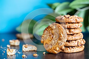 Whole and broken oatmeal cookies with peanuts on table