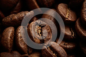 Whole brown coffee grains close-up.